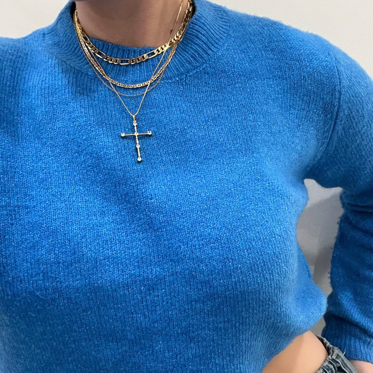 Close-up of cubic zirconia cross pendant on silver necklace