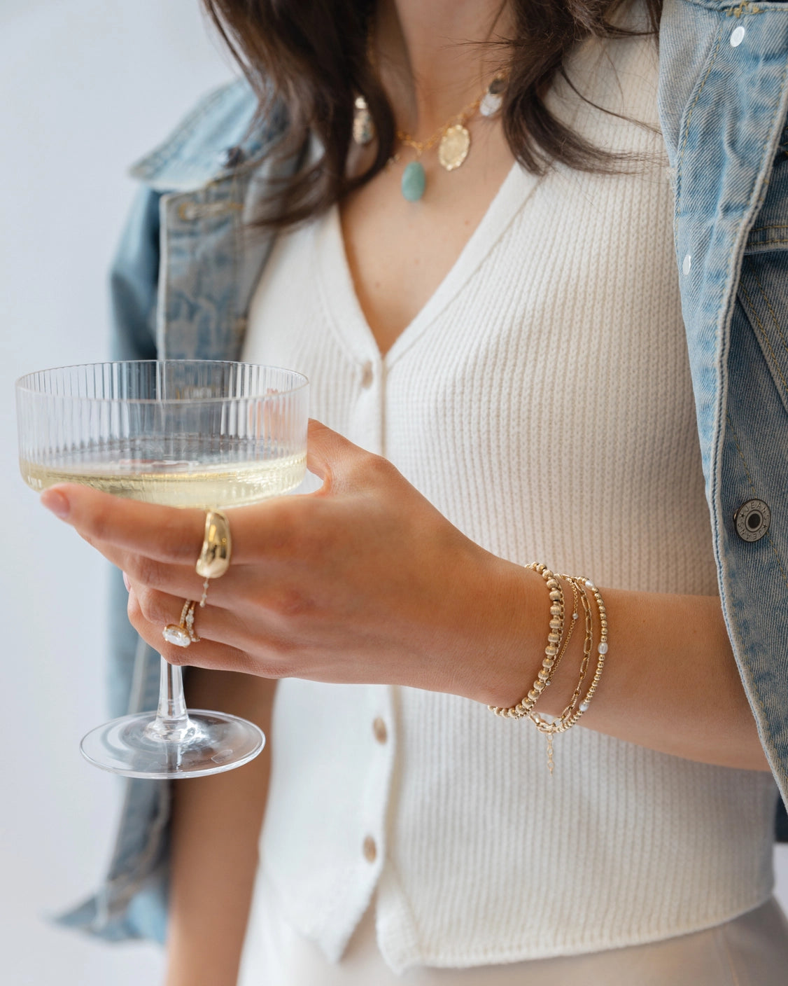 Freshwater pearl bracelet styled with layered gold jewelry