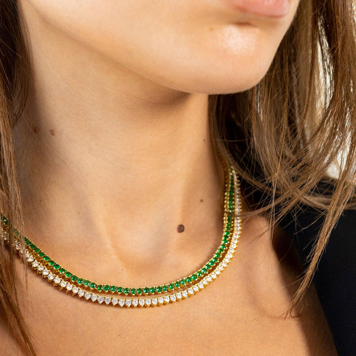 Woman wearing a gold CZ tennis necklace styled for an elegant look
