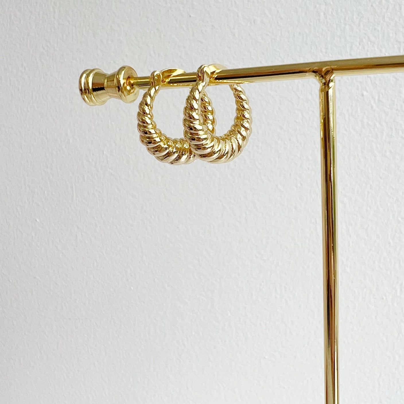 Close up of 14K gold-filled twisted hoop earrings for everyday style