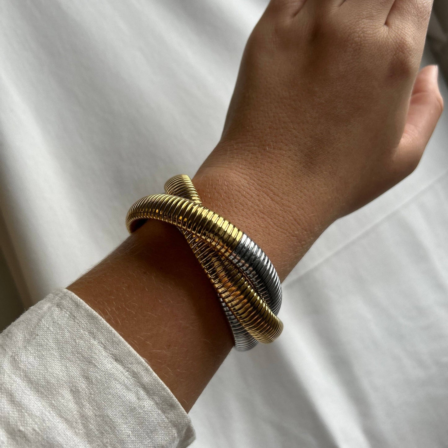 Mixed metal layered bracelet creating a stacked jewelry look