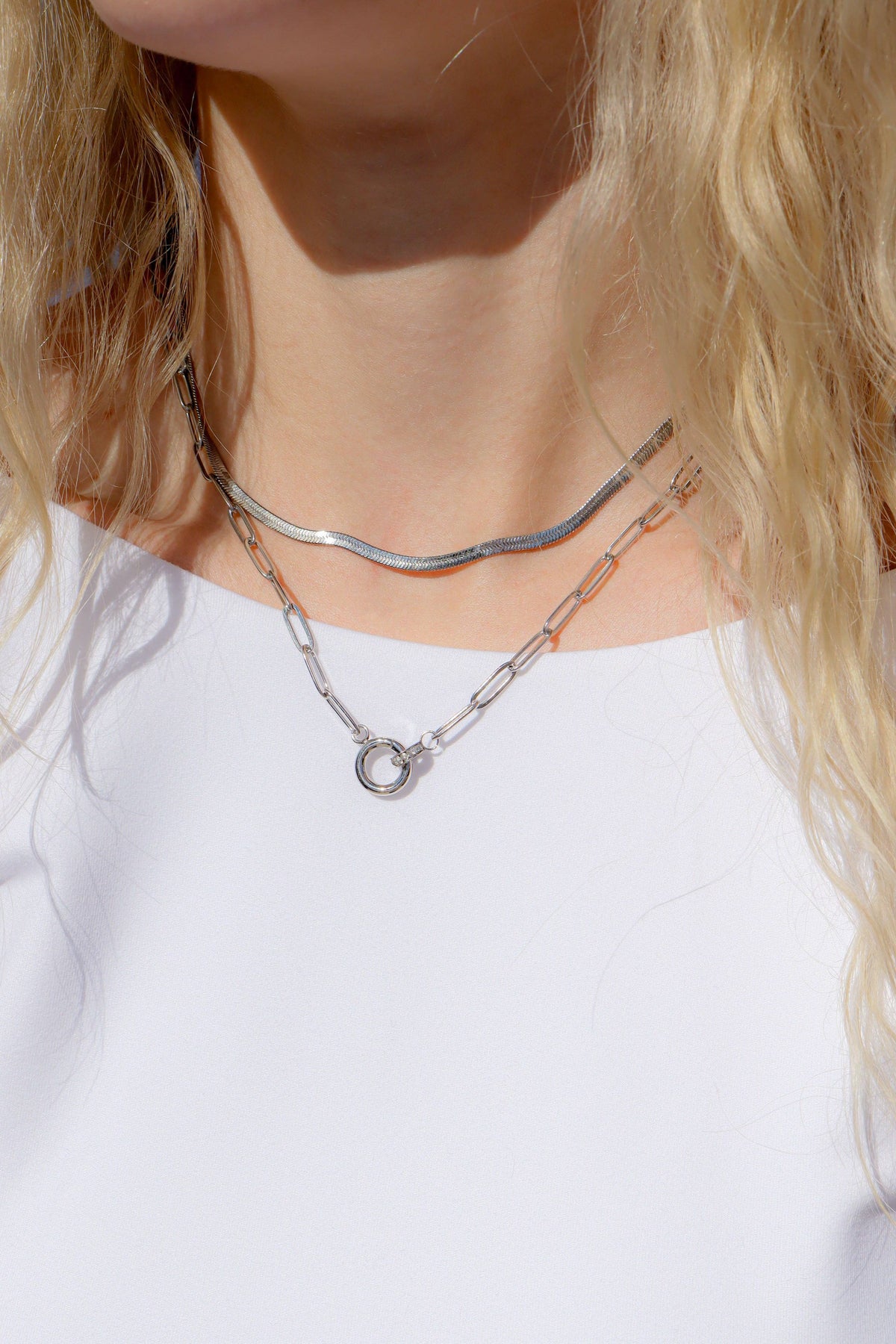 Paperclip charm necklace layered with silver jewelry