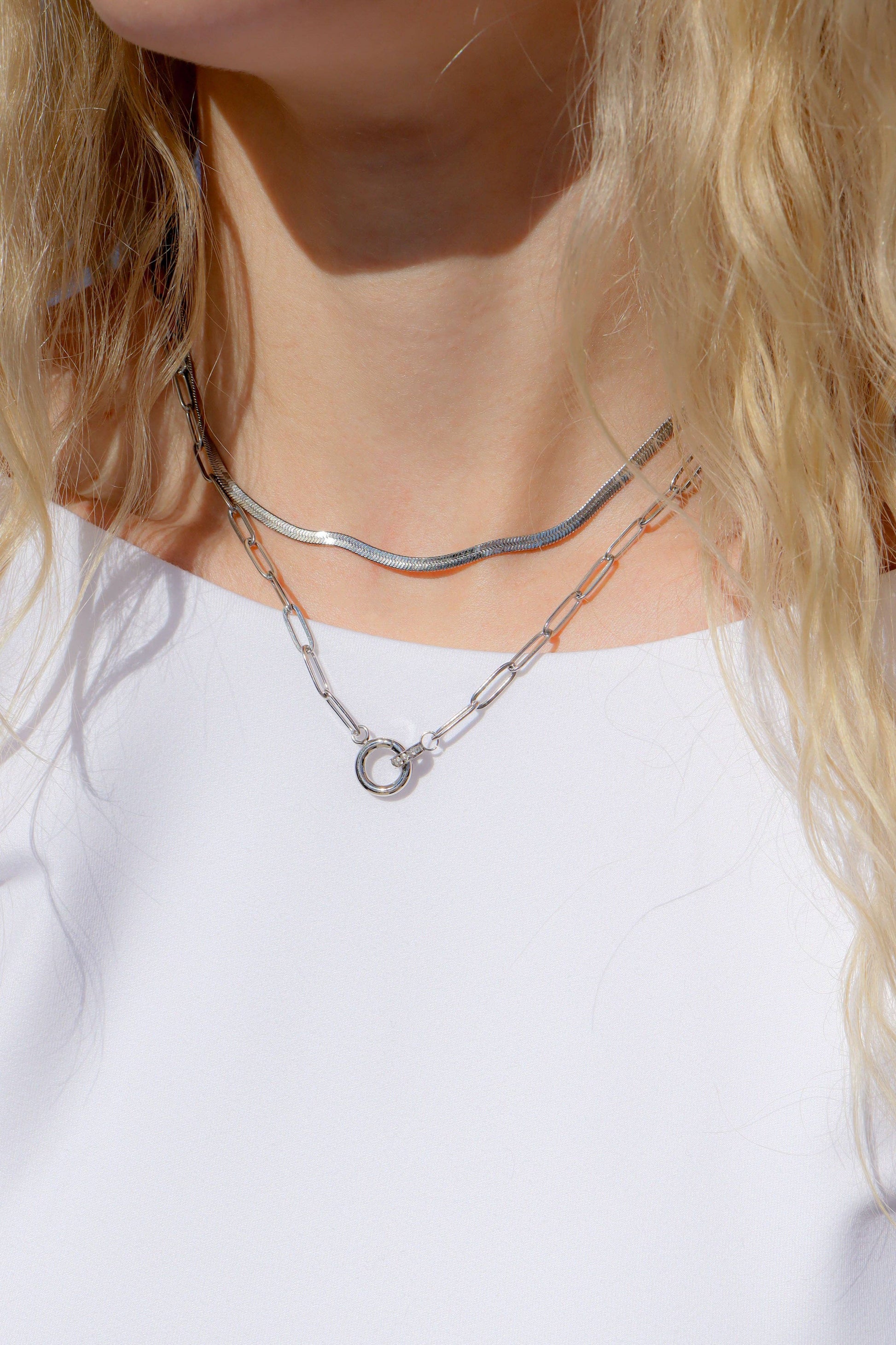 Paperclip charm necklace layered with silver jewelry