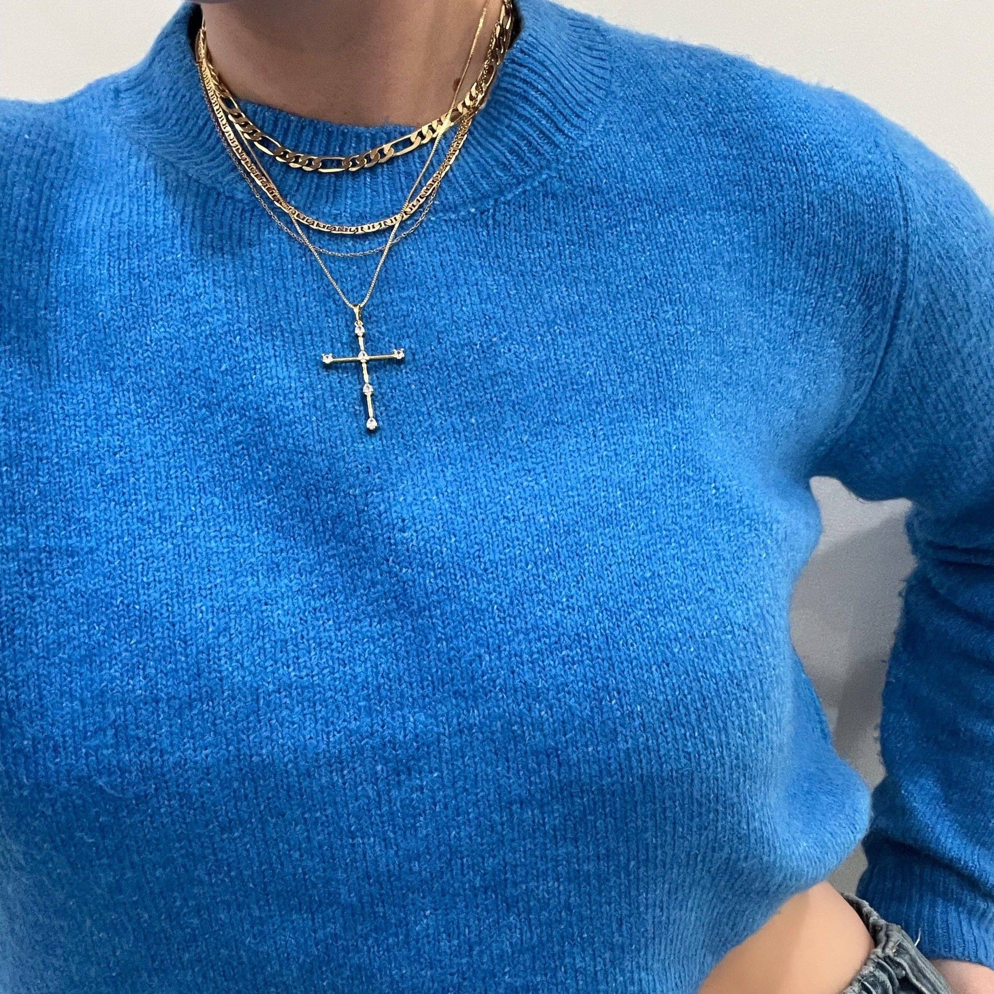 Close-up of cubic zirconia cross pendant on silver necklace