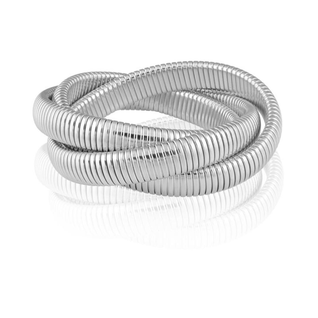Close-up of textured snake chain detail on layered silver bracelet